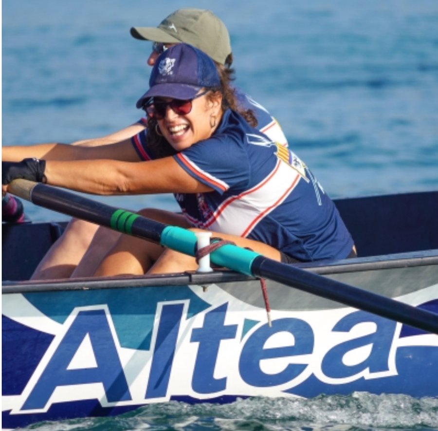 Alicia smiling while rowing on the water